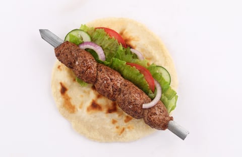 Indian style shish kofta kofte naan donner Skewer kebab flatbread sandwich with salad