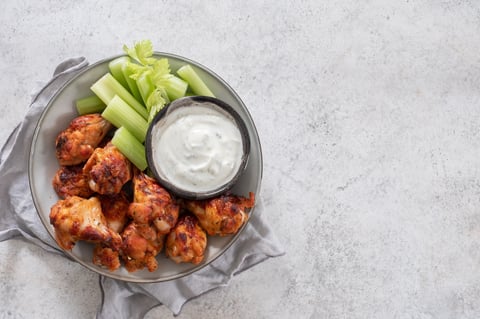 Buffalo chicken wings with celery and ranch sauce