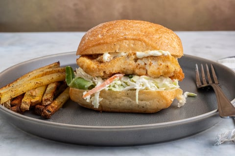 Haddock fillet sandwich with coleslaw and tartar sauce