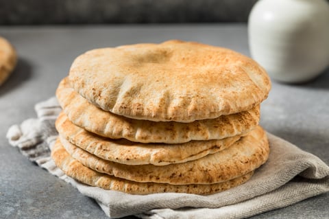 Homemade Greek pita bread pockets in a stack