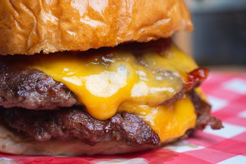 Juicy hamburger with melted cheese on a toasted bun