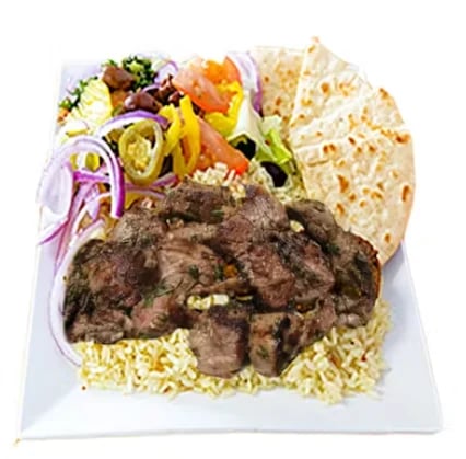 Plate of grilled meat with rice, fresh vegetables, and flatbread on a white plate